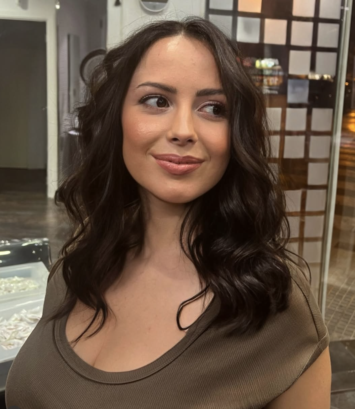 Glossy brunette waves styled at Carlos Rodes Hair Salon