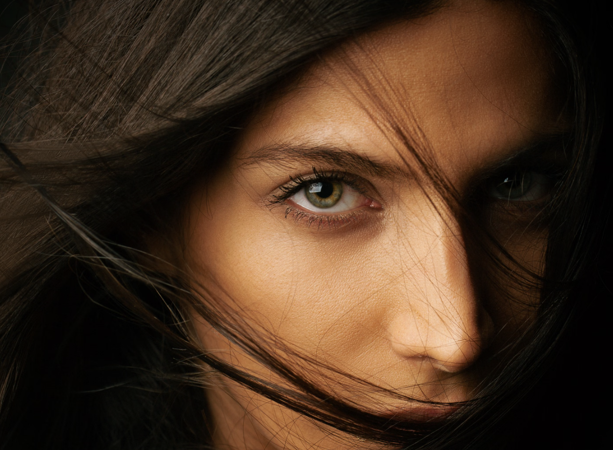 Editorial close-up portrait with flowing dark hair at Carlos Rodes