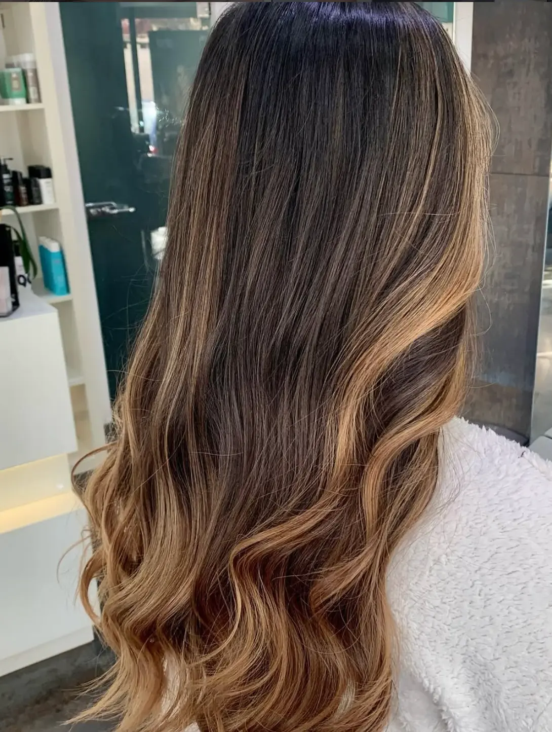 Caramel ombre waves over dark roots