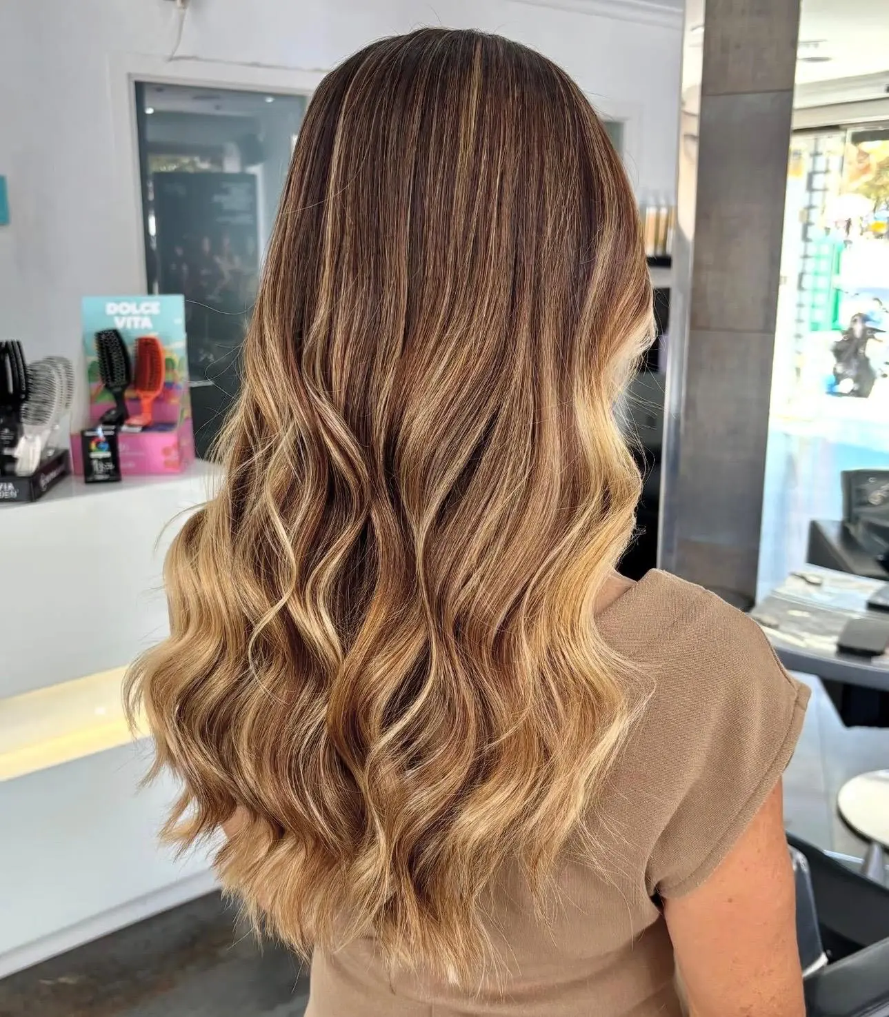 Golden balayage and soft waves viewed from the side