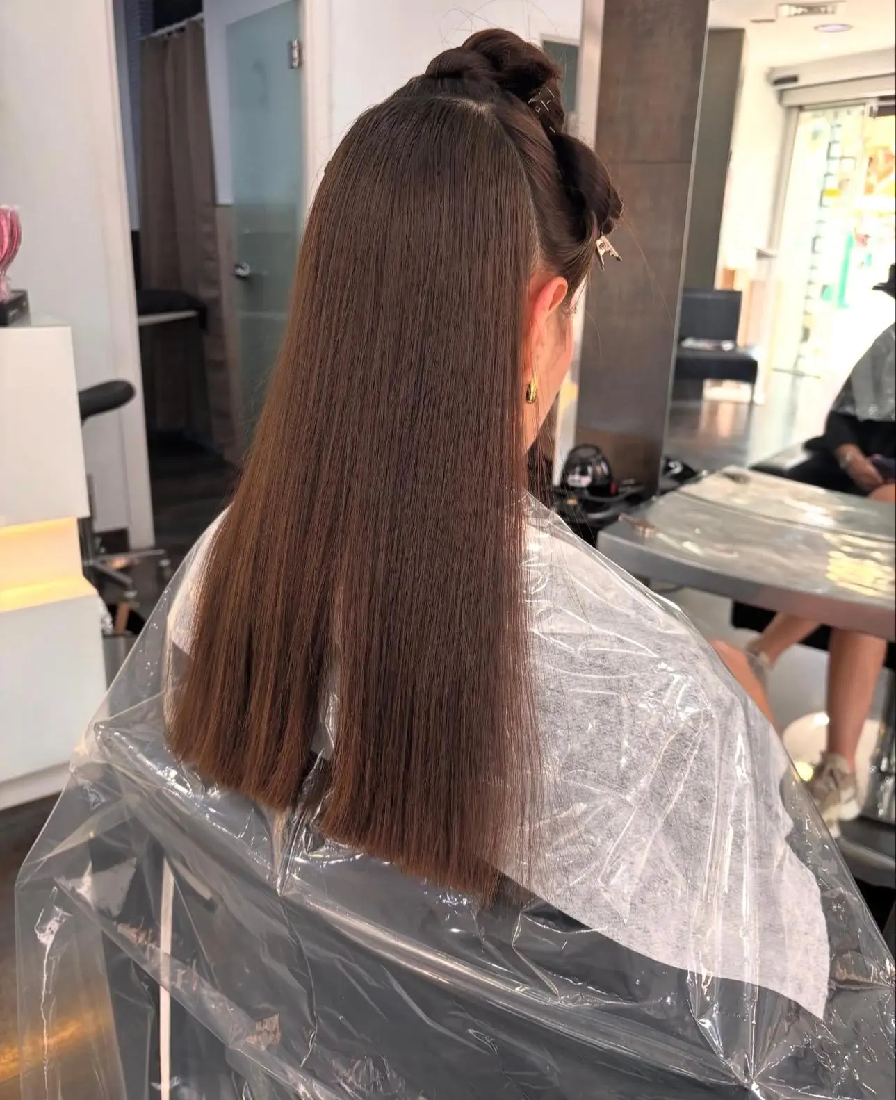Glass-smooth brunette blowout with a half-up twist